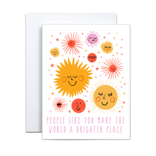 Load image into Gallery viewer, illustrated yellow, pink, and orange suns with various faces on a white background with the same color stars with 'people like you make the world a brighter place' in pink at the bottom greeting card