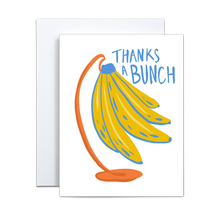 Load image into Gallery viewer, illustration of yellow bananas with blue details on an orange stand with 'thanks a bunch' written in blue greeting card