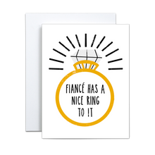 Load image into Gallery viewer, bold illustration of a gold wedding ring with a single large diamond with black lines for emphasis around the ring saying 'fiance has a nice ring to it' in the center of the ring greeting card