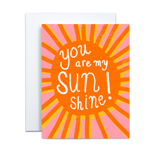 Load image into Gallery viewer, bold orange sun with rays offset by the same image in yellow on a pink background with &#39;you are my sunshine&#39; written in white in the center greeting card
