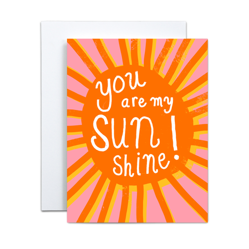 bold orange sun with rays offset by the same image in yellow on a pink background with 'you are my sunshine' written in white in the center greeting card