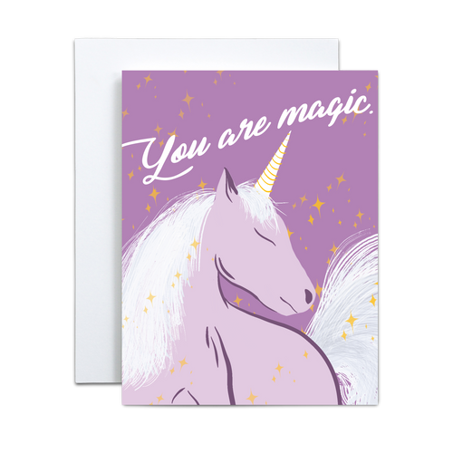 purple unicorn illustration with yellow stars surrounding on a purple background with 'you are magic' in script font on top greeting card