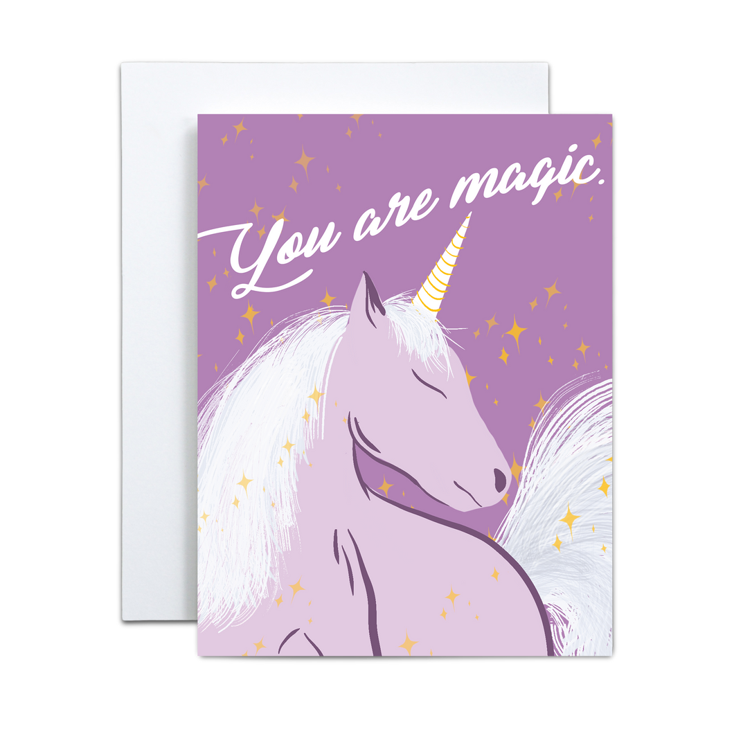 purple unicorn illustration with yellow stars surrounding on a purple background with 'you are magic' in script font on top greeting card