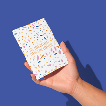 Load image into Gallery viewer, hand holding circular orange, pink, blue, light blue, and yellow confetti pattern with &#39;it&#39;s your birthday throw some confetti&#39; message in the middle in orange thin text birthday greeting card
