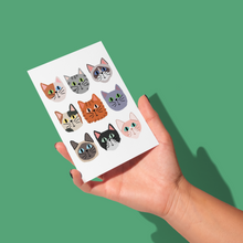 Load image into Gallery viewer, hand holding nine whimsical varying breed cat faces on a grid on a white background greeting card
