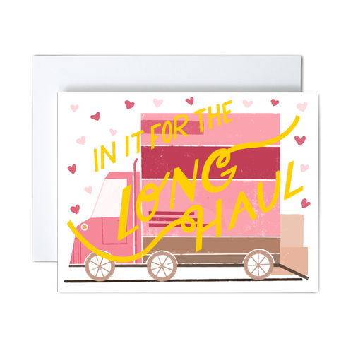 pink, dark pink, and shades of brown moving van with boxes ready to load and pink hearts with yellow 'in it for the long haul' script text over the front greeting card