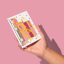Load image into Gallery viewer, hand holding pink, dark pink, and shades of brown moving van with boxes ready to load and pink hearts with yellow &#39;in it for the long haul&#39; script text over the front greeting card
