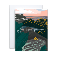 Load image into Gallery viewer, abstract mountain landscape with grey rocks and dark green mountains and green foliage with a blue and pink sunset and two small yellow birds sitting next to each other gazing out with &#39;i&#39;m here for you&#39; in white script font across the middle greeting card
