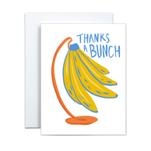 Load image into Gallery viewer, illustration of yellow bananas with blue details on an orange stand with &#39;thanks a bunch&#39; written in blue greeting card
